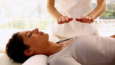 Woman getting reiki therapy