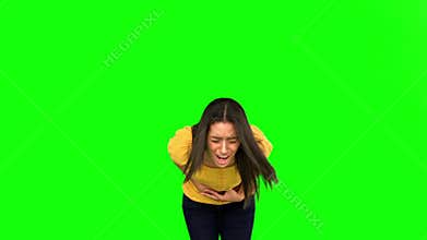 Woman suffering from belly pain on green screen