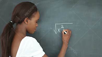 Video of a student writing on a blackboard
