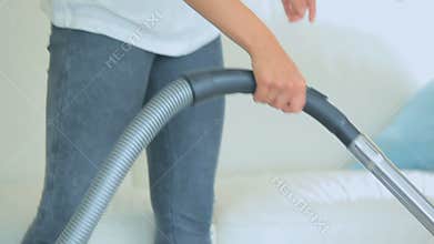 Woman vacuuming the carpet