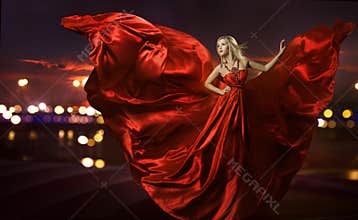 Woman dancing in silk dress, artistic red blowing