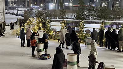 Families and couples spend time at a winter market decorated