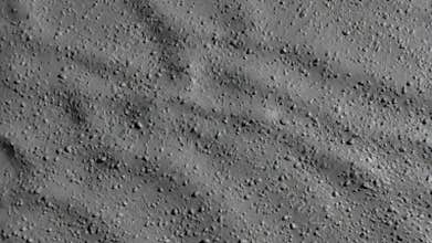 Abstract gray grainy surface with flowing shadow ripples