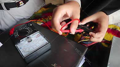 School students in Java, Indonesia, practice measuring DC electrical power