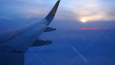 Istanbul, Turkiye - January 24, 2026: Pegasus Airlines Plane Wing Over Evening Clouds. Sunset Peeking Through Haze. Aircraft