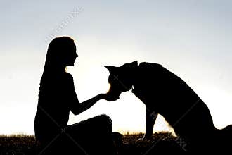 Woman Feeding Pet Dog Treats Silhouette