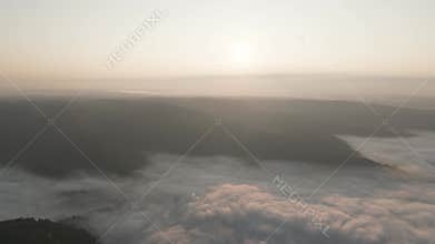 Stunning aerial sunrise view from Nongjrong viewpoint in Meghalaya, showing a sea of clouds filling the mountain valley