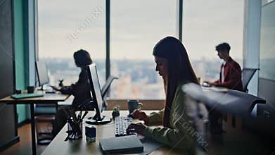Programmers silhouettes coding computers together at spacious coworking zone