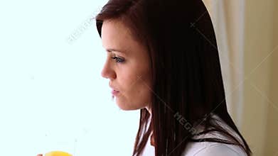 Young woman drinking orange juice