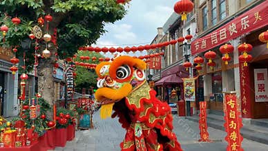 Vibrant chinese new year celebration featuring a traditional lion dance performance amidst festive decorations in a bustling
