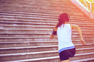 Woman running up on stone stairs