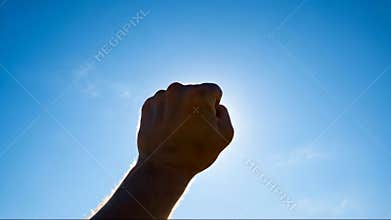 Hopeful Hand Reaching Up Towards Sunlight with Dramatic Backlight