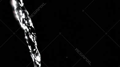 Close up, trickle of water in a super slow motion flowing