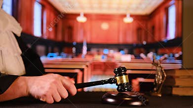 Judge striking gavel in courtroom for justice