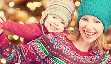 Happy family mother and little daughter playing in the winter for Christmas