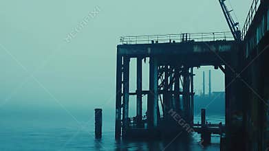 Industrial pier structure on a foggy moody day