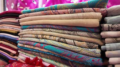 Colorful fabrics displayed in a vibrant market setting