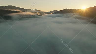 The Breathtaking Sunrise Creates Magic Over the Misty and Majestic Mountains Nearby