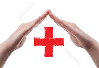 Hands protecting red cross concept