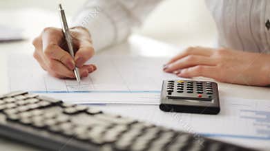 Accountant making calculations and taking notes
