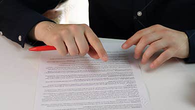 Dynamic hands of a businessman actively explaining and highlighting details on a contract. This clip represents