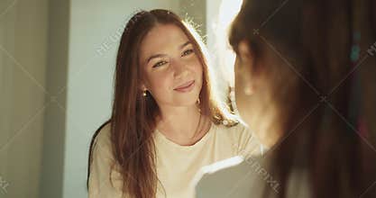 white mother listening and smiling at daughter bedside