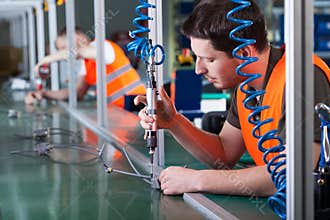 Men during precision work on production line