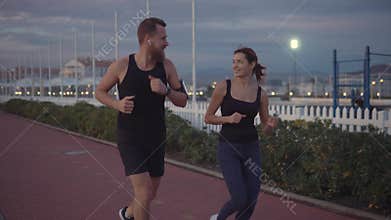 Friends talking and running in park.