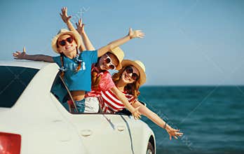 Happy family mother and children girls goes to summer travel trip in car