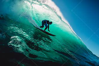 April 18, 2019. Bali, Indonesia. Surfer ride on barrel wave. Professional surfing at big waves in Padang Padang