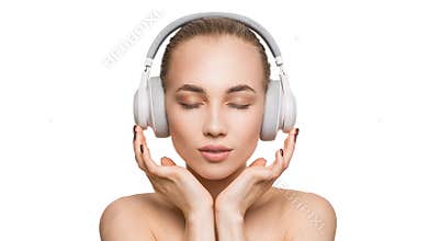 Woman in white headphones on white background listens to music with closed eyes.