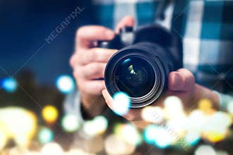 Professional photographer with camera. Man taking photos.