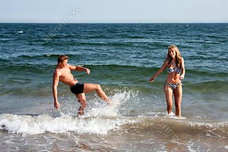 Couple playing in beach water