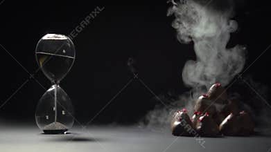 Liquid nitrogen pours on the pyramid of strawberries in chocolate.