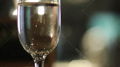 Glass filled with sparkling champagne on a restaurant table