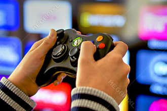 Playing video games on Xbox console, TV background