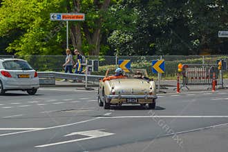 Old couple driving classic car