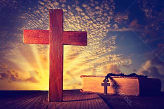 Christian wood cross on sunset sky