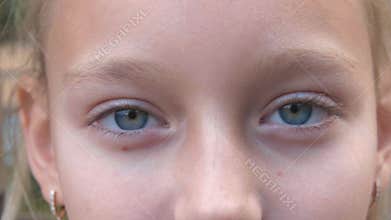 Young girl with closed eyes closeup. Face girl with gray eyes looking in camera