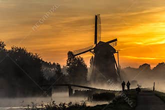 Sunrise heats up the canal water into the mist
