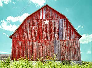 Old red star barn with aqua blue sky