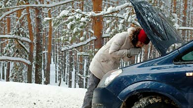 Woman with a straw car on the road in winter