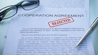 Cooperation agreement rejected, officials hand stamping seal on document