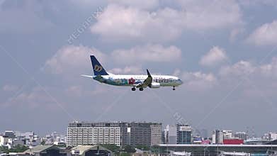 Airplane of Mandarin Airlines flying through clouds sky prepare to landing