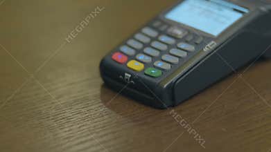 Closeup shot of customer pay over the wireless tradings card-reader. Adult human hands of businessman use bankcard