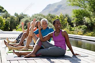 Mature group of people doing yoga exercise