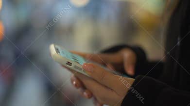 Lady typing on smartphone, standing in shopping center, free wifi connection