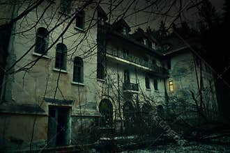 Old abandoned mansion in mystic spooky forest. The ancient haunted house of Frankenstein with dark horror atmosphere and creepy