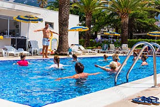 The fitness instructor holds an aqua aerobics class at the Hotel