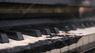 Scorched down to coal smoking piano keyboard